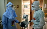 Medical workers in the coronavirus ward at Ichilov Hospital in Tel Aviv, on January 1, 2021. (Tomer Neuberg/Flash90)