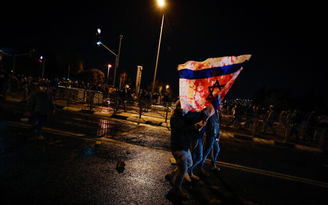 People protest over the death of Ahuvia Sandak in a car crash during a police chase, near the Police Internal Investigations Department in Jerusalem on January 2, 2021 (Olivier Fitoussi/Flash90)