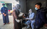 Palestinian Health worker takes samples for coronavirus at a health center in Rafah, in the southern Gaza Strip, on January 5, 2020. (Abed Rahim Khatib/Flash90)