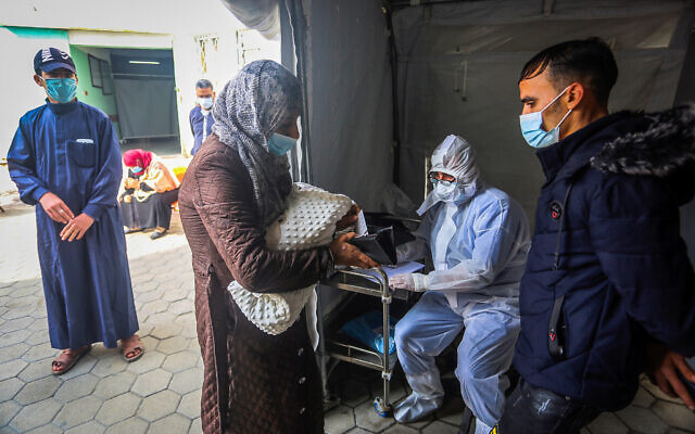 Palestinian Health worker takes samples for coronavirus at a health center in Rafah, in the southern Gaza Strip, on January 5, 2020. (Abed Rahim Khatib/Flash90) Palestinian Health worker takes samples for coronavirus at a health center in Rafah, in the southern Gaza Strip, on January 5, 2020. (Abed Rahim Khatib/Flash90)