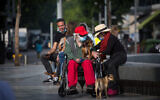 People in Tel Aviv, some wearing protective face masks, on January 6, 2021 (Miriam Alster/FLASH90)