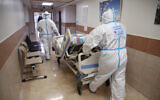 Ziv hospital team members transport a new patient at the coronavirus ward of the hospital  in the northern city of Safed on January 7, 2020. (David Cohen/Flash90)