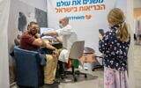 Man receives a COVID-19 vaccine, at a Meuhedet vaccination center in Jerusalem, on January 7, 2021. (Yonatan Sindel/Flash90)