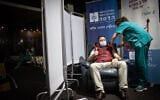 A Hadassah Medical Center staff member receives the second round of the COVID-19 vaccine in Jerusalem, January 11, 2021. (Yonatan Sindel/Flash90)