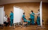 Hadassah Medical Center staff members receive the second round of the COVID-19 vaccine, at the Hadassah Medical Center, in Jerusalem, January 11, 2021. (Yonatan Sindel/Flash90)