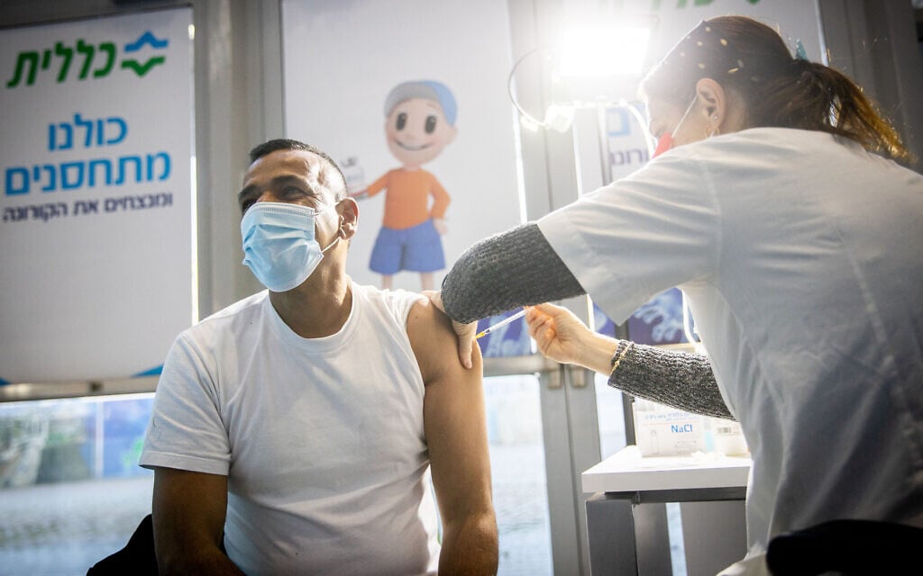 A man receives a coronavirus vaccine injection at Clalit vaccination center in Jerusalem on January 12, 2021. (Yonatan Sindel/Flash90) A man receives a coronavirus vaccine injection at Clalit vaccination center in Jerusalem on January 12, 2021. (Yonatan Sindel/Flash90)