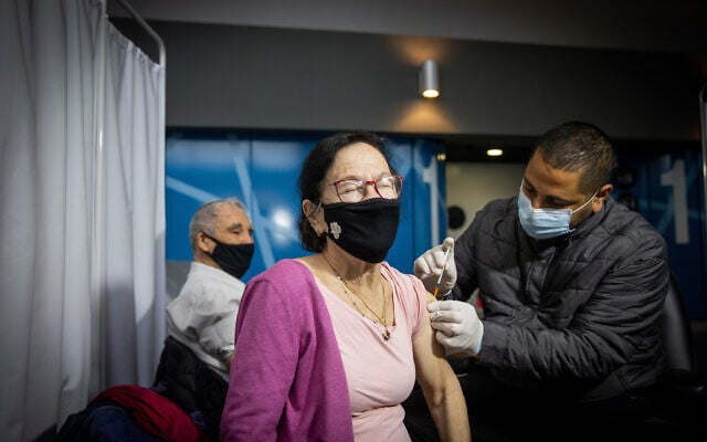 A woman receives a COVID-19 vaccine injection, at a Clalit Health Services vaccination center in Jerusalem, on January 18, 2021. (Yonatan Sindel/Flash90) A woman receives a COVID-19 vaccine injection, at a Clalit Health Services vaccination center in Jerusalem, on January 18, 2021. (Yonatan Sindel/Flash90)