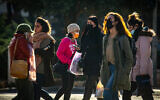 Jerusalem residents walk in downtown Jerusalem on January 21,  2021, during the 3rd lockdown due to the COVID-19 coronavirus pandemic. (Olivier Fitoussi/Flash90)