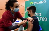 An Israeli student receives a COVID-19 vaccination, at a Kupat HolimLeumit center in Tel Aviv, on January 23, 2021. (Avshalom Sassoni/Flash90)