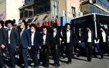 Ultra-Orthodox protesters demonstrate against a police enforcement of lockdown orders due to the coronavirus, in the city of Bnei Brak, January 24, 2021. (Tomer Neuberg/Flash90)