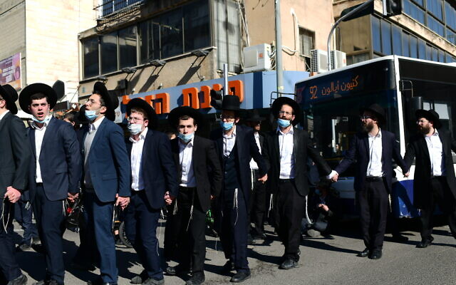 Ultra-Orthodox protesters demonstrate against a police enforcement of lockdown orders due to the coronavirus, in the city of Bnei Brak, January 24, 2021. (Tomer Neuberg/Flash90) Ultra-Orthodox protesters demonstrate against a police enforcement of lockdown orders due to the coronavirus, in the city of Bnei Brak, January 24, 2021. (Tomer Neuberg/Flash90)