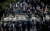 Police clash with Ultra-Orthodox Jewish men during enforcement of coronavirus  regulations, in Mea Shearim, Jerusalem, January 24, 2021 (Yonatan Sindel/Flash90)
