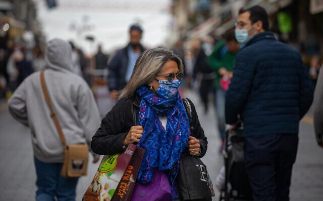 People wearing face masks walk in the Jerusalem city center on January 26, 2020, with Israel under its 3rd lockdown due to the coronavirus pandemic. (Olivier Fitoussi/Flash90) People wearing face masks walk in the Jerusalem city center on January 26, 2020, with Israel under its 3rd lockdown due to the coronavirus pandemic. (Olivier Fitoussi/Flash90)