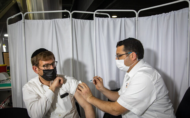 Illustrative: A man receives a COVID-19 vaccine injection in Jerusalem, on January 28, 2021. (Olivier Fitoussi/Flash90) Illustrative: A man receives a COVID-19 vaccine injection in Jerusalem, on January 28, 2021. (Olivier Fitoussi/Flash90)