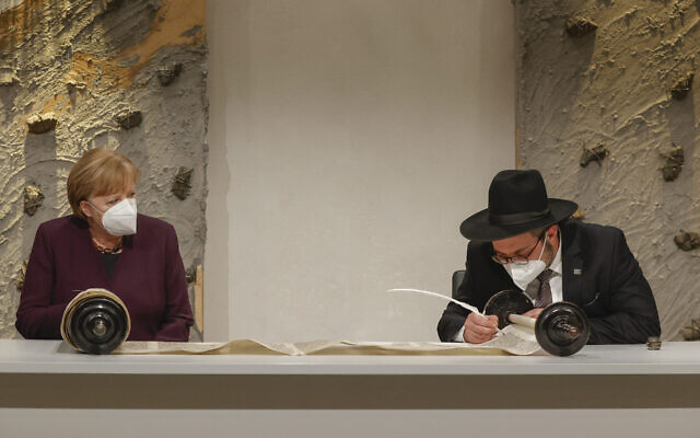 Rabbi Shaul Nekrich (R) and German Chancellor Angela Merkel (L) attend a ceremony to complete the historic Sulzbach Torah Scroll from 1792, rediscovered in 2015 and just restored, on the 76th anniversary of the liberation of Nazi Germany's Auschwitz death camp, on International Holocaust Remembrance Day, January 27, 2021 in Berlin, Germany. (Odd Andersen/Getty Images via JTA) Rabbi Shaul Nekrich (R) and German Chancellor Angela Merkel (L) attend a ceremony to complete the historic Sulzbach Torah Scroll from 1792, rediscovered in 2015 and just restored, on the 76th anniversary of the liberation of Nazi Germany's Auschwitz death camp, on International Holocaust Remembrance Day, January 27, 2021 in Berlin, Germany. (Odd Andersen/Getty Images via JTA)