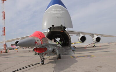 A retired Israeli F-16 fighter jet is loaded into a cargo plane as it is sold to a North American company on January 27, 2021. (Defense Ministry)