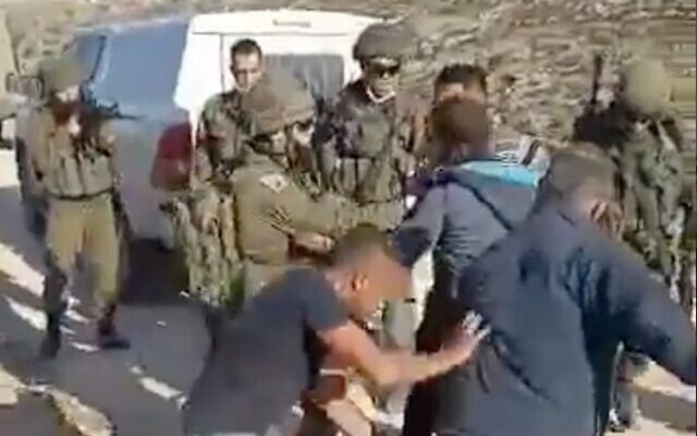Palestinians scuffle with Israeli soldiers outside of al-Tuwani, southeast of Yatta, in the South Hebron Hills in the West Bank, on January 1, 2021. (Screenshot) Palestinians scuffle with Israeli soldiers outside of al-Tuwani, southeast of Yatta, in the South Hebron Hills in the West Bank, on January 1, 2021. (Screenshot)