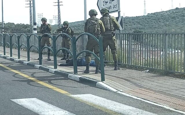 Israeli soldiers surround a Palestinian man suspected of trying to stab them in the northern West Bank on January 26, 2021. (Screen capture) Israeli soldiers surround a Palestinian man suspected of trying to stab them in the northern West Bank on January 26, 2021. (Screen capture)