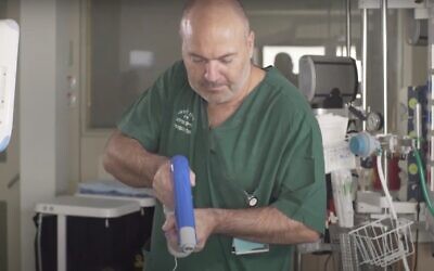 Screen capture from video of a doctor using the Spincare spray-on system to treat a patient's wounds. (YouTube)