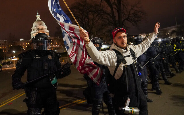 A police line moves a protestor outside of the US Capitol following violent riots there, January 6, 2021. (AP Photo/John Minchillo) A police line moves a protestor outside of the US Capitol following violent riots there, January 6, 2021. (AP Photo/John Minchillo)