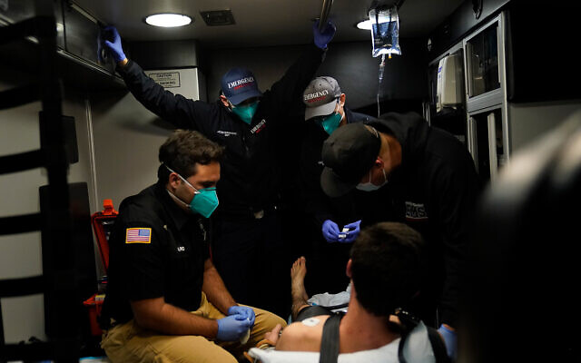 Emergency medical workers treat a patient in an ambulance during a severe COVID-19 outbreak in Placentia, California, January 8, 2021. (AP Photo/Jae C. Hong) Emergency medical workers treat a patient in an ambulance during a severe COVID-19 outbreak in Placentia, California, January 8, 2021. (AP Photo/Jae C. Hong)