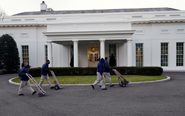 Workers walk with hand trucks past the West Wing of the White House, as offices in the White House complex are being packed up and moved out, Jan. 15, 2021. (AP Photo/Gerald Herbert) Workers walk with hand trucks past the West Wing of the White House, as offices in the White House complex are being packed up and moved out, Jan. 15, 2021. (AP Photo/Gerald Herbert)