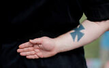 Illustrative: A neo-Nazi tattoo at a rally in Newnan, Georgia, April 21, 2018. (AP Photo/David Goldman)