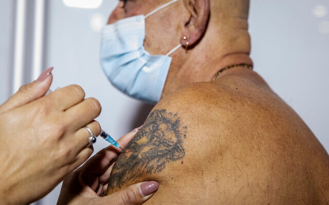 Illustrative: A COVID-19 vaccine is administered in Jerusalem, January 4, 2021. (Olivier Fitoussi/Flash90) Illustrative: A COVID-19 vaccine is administered in Jerusalem, January 4, 2021. (Olivier Fitoussi/Flash90)