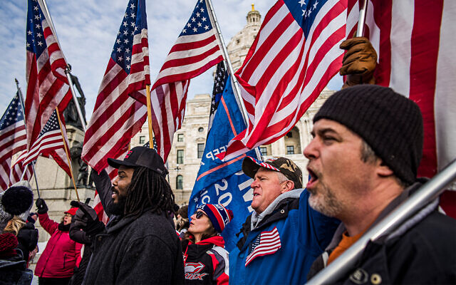 Protesters rally in support of US President Donald Trump on the steps of the Minnesota State Capitol in St. Paul, Minnesota, January 6, 2021. (Richard Tsong-Taatarii/Star Tribune via AP) Protesters rally in support of US President Donald Trump on the steps of the Minnesota State Capitol in St. Paul, Minnesota, January 6, 2021. (Richard Tsong-Taatarii/Star Tribune via AP)