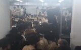 Hundreds of ultra-Orthodox men from the Toldos Aharon Hasidic dynasty attend a wedding in Beitar Illit, violating coronavirus regulations, January 5, 2021. (Screenshot: Twitter)