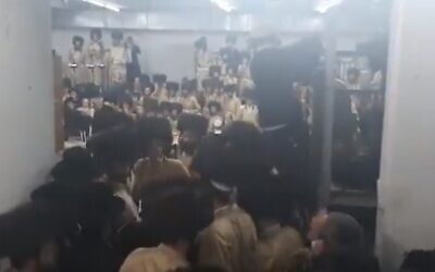 Hundreds of ultra-Orthodox men from the Toldos Aharon Hasidic dynasty attend a wedding in Beitar Illit, violating coronavirus regulations, January 5, 2021. (Screenshot: Twitter)