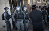 Police officers seen during clashes with ultra-Orthodox men over coronavirus lockdown restrictions, Jerusalem, January 26, 2021. (Yonatan Sindel/Flash90)