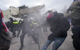 Pro-Trump rioters try to break through a police barrier at the US Capitol in Washington, January 6, 2021. (AP Photo/Julio Cortez)