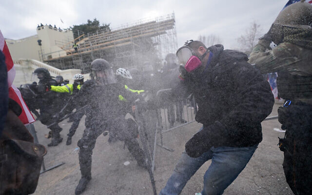 Pro-Trump rioters try to break through a police barrier at the US Capitol in Washington, January 6, 2021. (AP Photo/Julio Cortez) Pro-Trump rioters try to break through a police barrier at the US Capitol in Washington, January 6, 2021. (AP Photo/Julio Cortez)