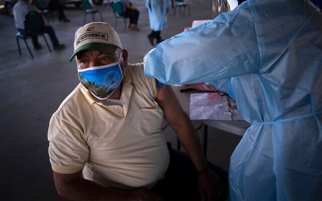 A farm worker receives the Pfizer-BioNTech COVID-19 vaccine at Tudor Ranch in Mecca, California, Jan. 21, 2021. (AP Photo/Jae C. Hong) A farm worker receives the Pfizer-BioNTech COVID-19 vaccine at Tudor Ranch in Mecca, California, Jan. 21, 2021. (AP Photo/Jae C. Hong)