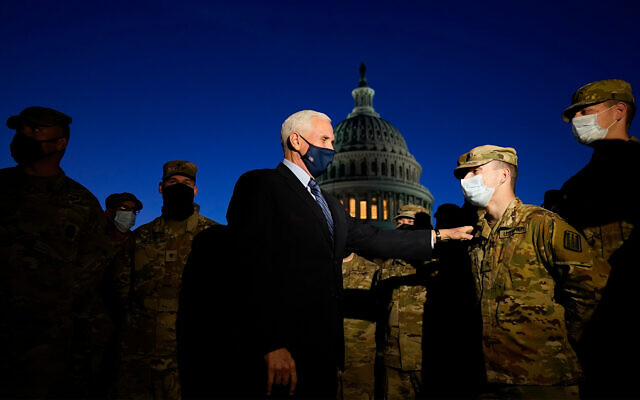 US Vice President Mike Pence speaks to National Guard troops outside the US Capitol in Washington, January 14, 2021. (AP Photo/Alex Brandon, Pool) US Vice President Mike Pence speaks to National Guard troops outside the US Capitol in Washington, January 14, 2021. (AP Photo/Alex Brandon, Pool)