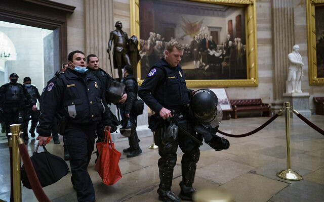 US Capitol Police officers walk through the Rotunda as they and other federal police forces respond to violent rioters loyal to President Donald Trump at the Capitol in Washington, January 6, 2021. (AP Photo/J. Scott Applewhite) US Capitol Police officers walk through the Rotunda as they and other federal police forces respond to violent rioters loyal to President Donald Trump at the Capitol in Washington, January 6, 2021. (AP Photo/J. Scott Applewhite)