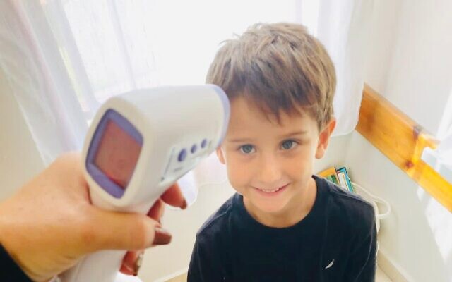 A kindergarten pupil in Ashdod has his temperature taken by the Thermoguard device (courtesy of Thermoguard) A kindergarten pupil in Ashdod has his temperature taken by the Thermoguard device (courtesy of Thermoguard)