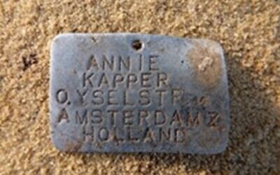 A name tag of a child found during excavations at Sobibor death camp in Poland. (Courtesy)