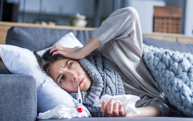 A woman suffering from the flu (monstArrr_ via iStock by Getty Images)