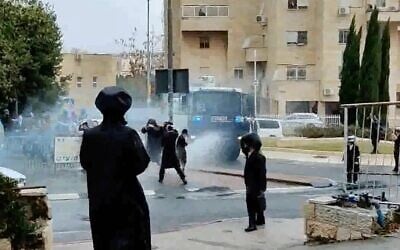 Screen capture from video as police use a water cannon to disperse protesters against enforcement of a national lockdown due to the coronavirus outbreak, in Jerusalem, January 20, 2021. (Kikar Shabbat)