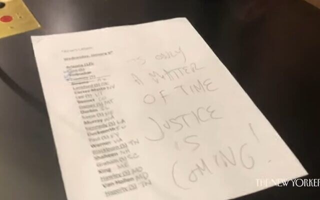 A note written by Jacob Chansley aka Jake Angeli and left on US Vice President Mike Pence's desk reads: "It's only a matter of time, Justice is coming!" (Screenshot/YouTube)