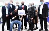 Prime Minister Benjamin Netanyahu (C) with Muhammad Abd al-Wahhab Jabarin, the millionth Israeli to get a COVID-19 vaccine, and medical staff in Umm al-Fahm, January 1, 2021. (Haim Zach/GPO)