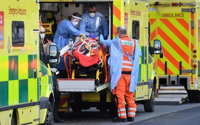 London Ambulance staff stretcher a patient from the ambulance into The Royal London Hospital in east London, on January 2, 2021. (DANIEL LEAL-OLIVAS / AFP) London Ambulance staff stretcher a patient from the ambulance into The Royal London Hospital in east London, on January 2, 2021. (DANIEL LEAL-OLIVAS / AFP)