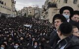 Thousands of ultra-Orthodox Jews attend a funeral procession for the Head of the Brisk Yeshiva, Rabbi Meshulam Dovid Soloveitchik, in Jerusalem on January 31, 2021, following his passing aged 99 due to months-long illness compounded by the coronavirus. (MENAHEM KAHANA / AFP)
