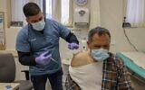 A health worker administers a dose of the Pfizer-BioNtech COVID-19 vaccine in East Jerusalem on February 3, 2021. (AHMAD GHARABLI / AFP)