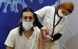 Illustrative: An Israeli health worker administers a dose of the Pfizer-BioNtech Covid-19 vaccine at Clalit Health Services, in a gymnasium in the central Israeli city of Hod Hasharon, on February 4, 2021. (JACK GUEZ / AFP)