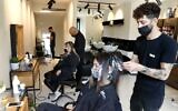 Women get their hair styled at a salon in Tel Aviv on February 7, 2021, following the lifting of a nationwide lockdown due to the COVID-19 pandemic. (JACK GUEZ / AFP)