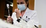 A medical staff member prepares the AstraZeneca-Oxford COVID-19 vaccine at the Mignot Hospital in Le Chesnay, near Paris, on February 7, 2021 (ALAIN JOCARD / AFP)