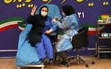 Iranian health worker Sara Gudarzi receives the COVID-19 vaccine as the country launches its inoculation campain, at the Imam Khomeini hospital in the capital Tehran, on February, 9, 2021 (ATTA KENARE / AFP)